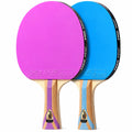 Two table tennis rackets with wooden handles, one featuring a pink rubber and the other a blue rubber, displayed against a solid white background.